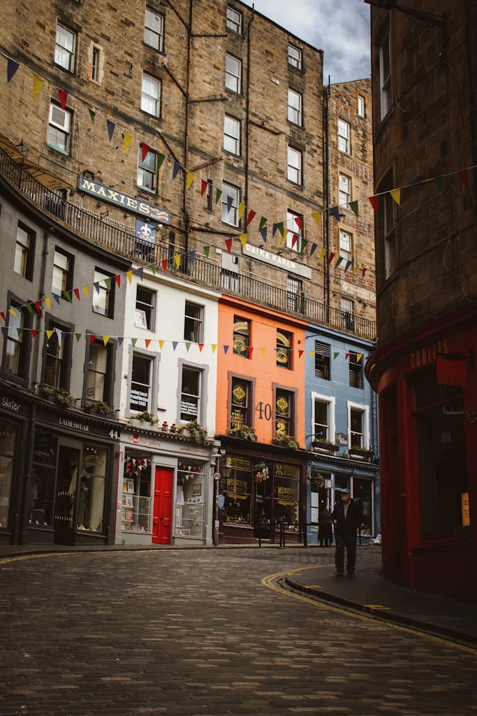 Explore the vibrant colors and historic charm of Victoria Street in Edinburgh, Scotland, with its unique architecture and festive atmosphere.
