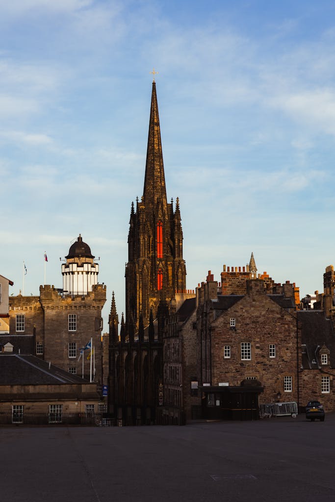 Historic buildings and church spire in Edinburgh, Scotland during a sunny day. A beautiful example of Gothic architecture.