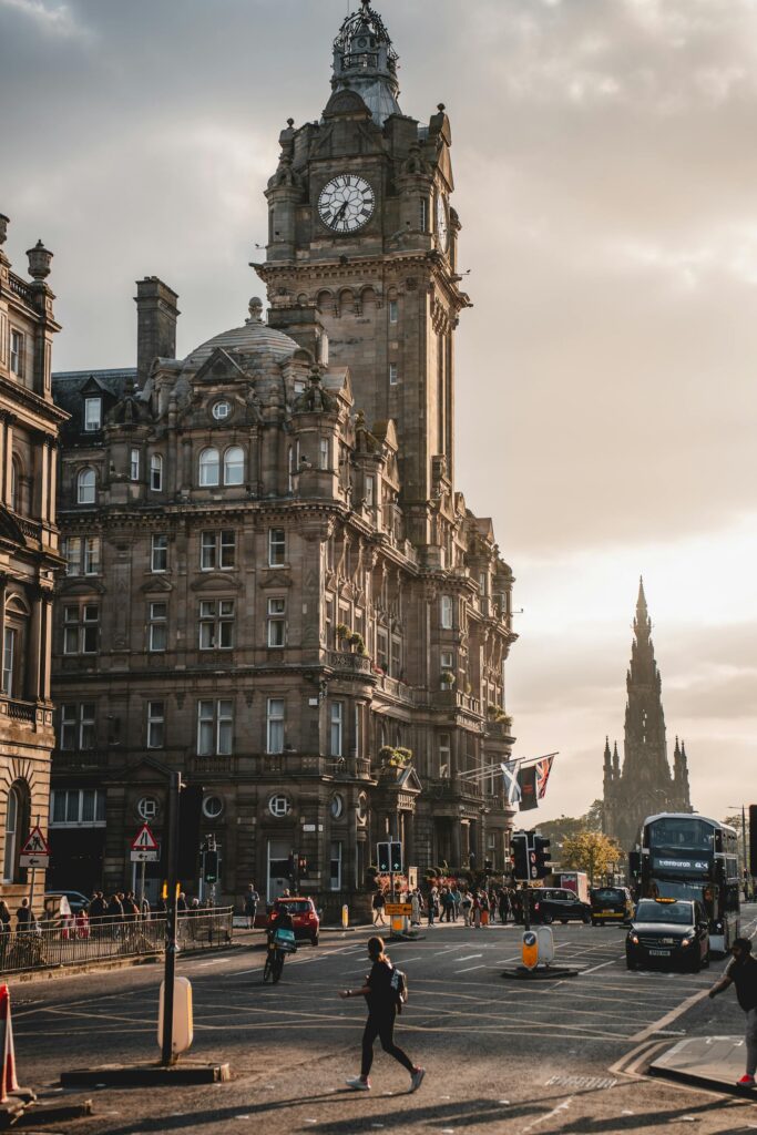 Iconic view of Edinburgh's Balmoral Hotel and Scott Monument at sunset