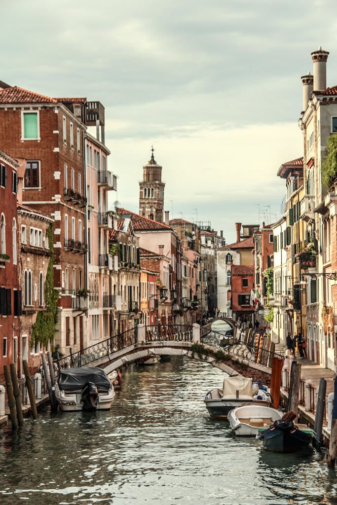 Picturesque canal in Venice with boats and historic buildings creating a charming view.