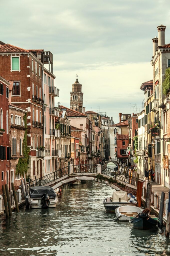 Picturesque canal in Venice with boats and historic buildings creating a charming view.